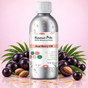 A bottle of Raasa Oils Acai Berry Oil centered on a pink background, surrounded by whole and halved acai berries, green leaves, and scattered golden oil droplets. The bottle is metallic silver with a white cap and a white label featuring the Raasa Oils brand name.