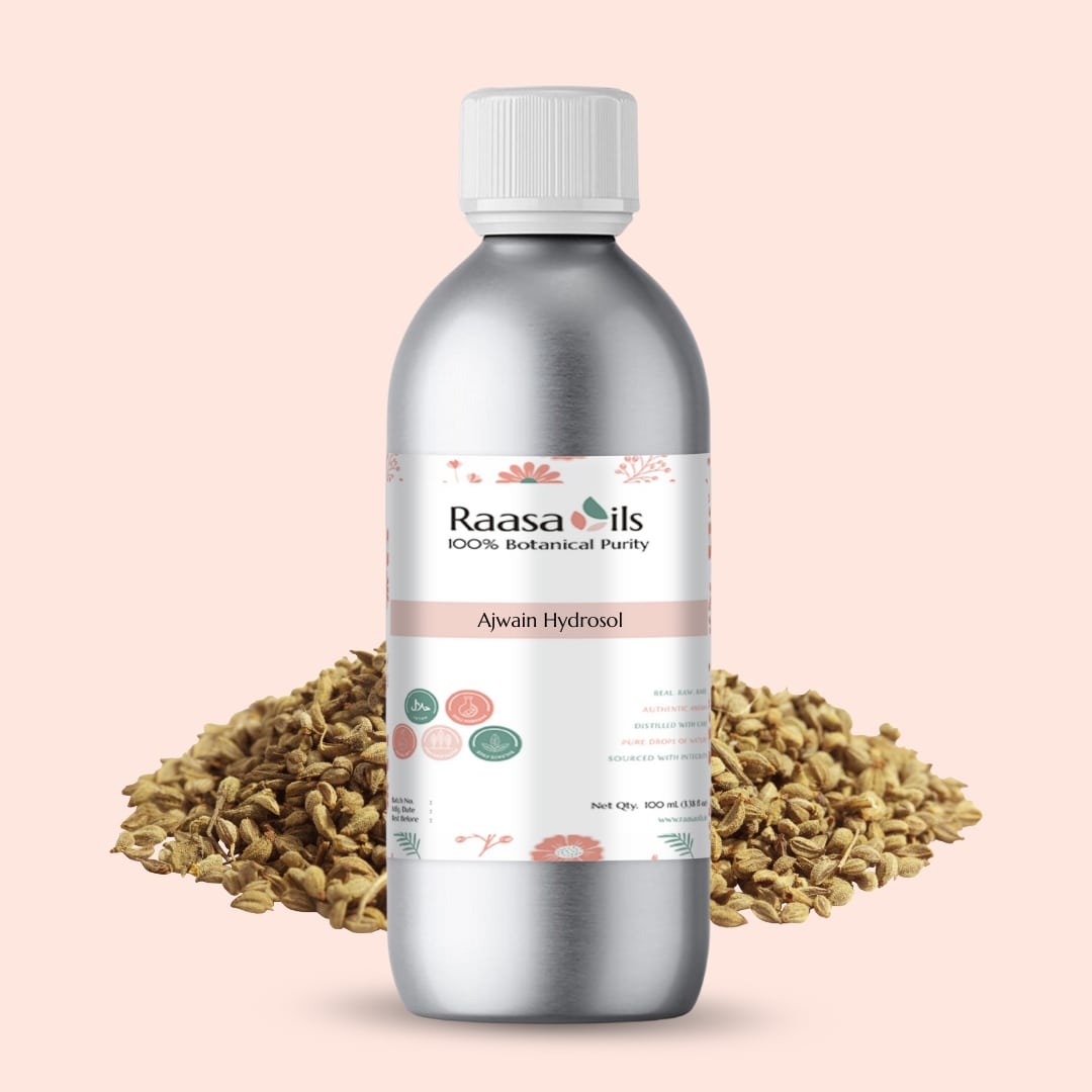 Bottle of Raasa Oils Alwain Hydrosol with fennel seeds on a pink background