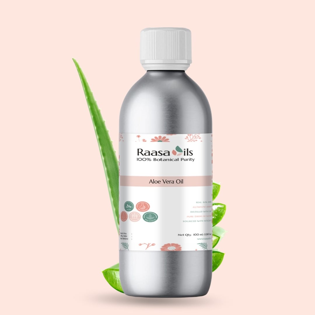 Bottle of Raasa Oils Aloe Vera Oil with a green leaf on a light pink background