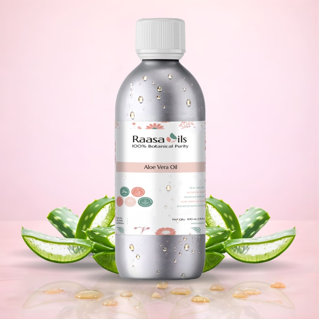 Bottle of Raasa Oils Aloe Vera Oil with a pink background and aloe vera leaves.