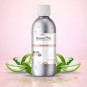 Bottle of Raasa Oils Aloe Vera Oil with a pink background and aloe vera leaves.