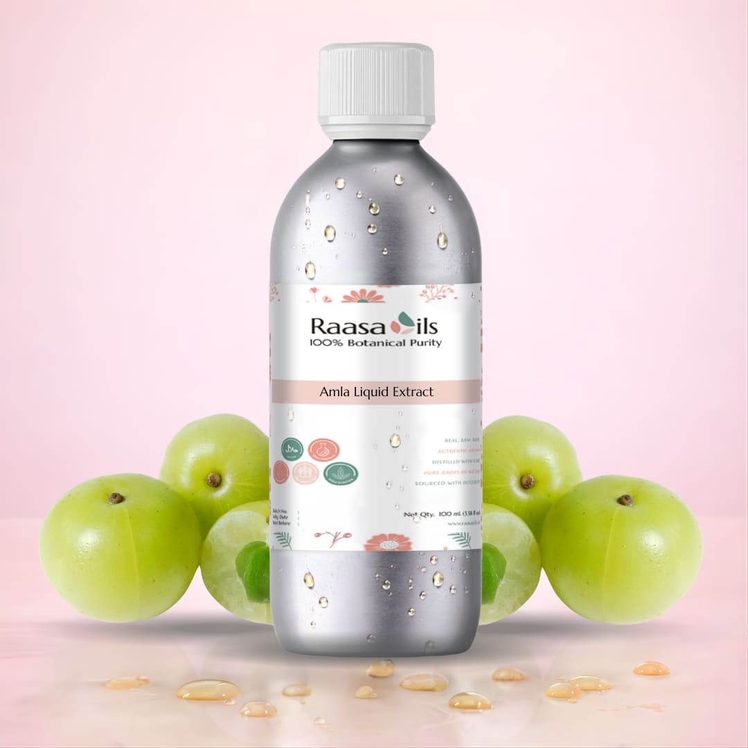 Bottle of Raasa Oils Amla Liquid Extract with gooseberries on a pink background