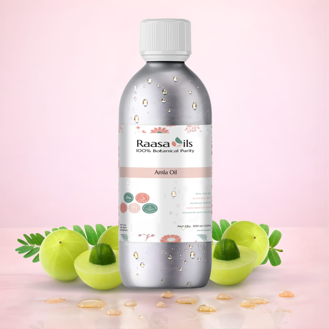 Bottle of Raasa Oils Amla Oil with a pink background and amla fruits.