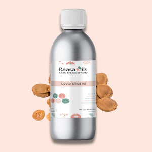 Raasa Oils apricot kernel oil bottle with almonds on a pink background