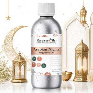 A bottle of Raasa Ils Arabian Nights Fragrance Oil, 100% botanical purity, in a metallic silver bottle with a white cap. The bottle is decorated with water droplets and features a white label with pink and green accents.