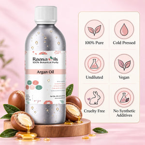 A bottle of Raasa oils Argan Oil centered on a pink background, surrounded by argan nuts, green leaves, and golden oil droplets. A vertical panel on the right lists product benefits: 100% Pure, Cold Pressed, Undiluted, Vegan, Cruelty Free, and No Synthetic Additives.