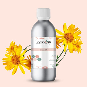Bottle of Raasa Oils Arnica Oil with yellow flowers on a light pink background
