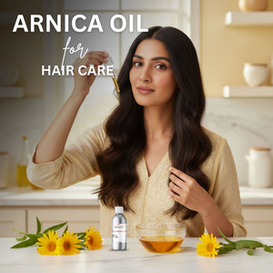 Woman with long hair in a kitchen setting with Arnica oil and flowers.