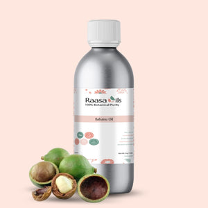 Bottle of Raasa Oils Babassu Oil with nuts on a light pink background