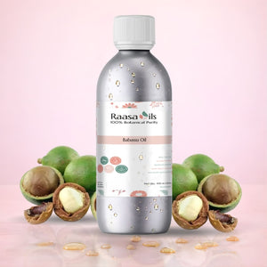 Bottle of Raasa Oils Babassu Oil with green fruits and seeds on a pink background