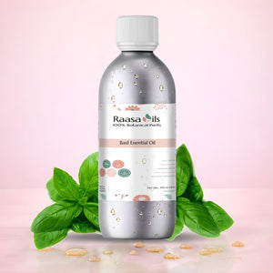 Bottle of Raasa Oils Basil Essential Oil with basil leaves on a pink background