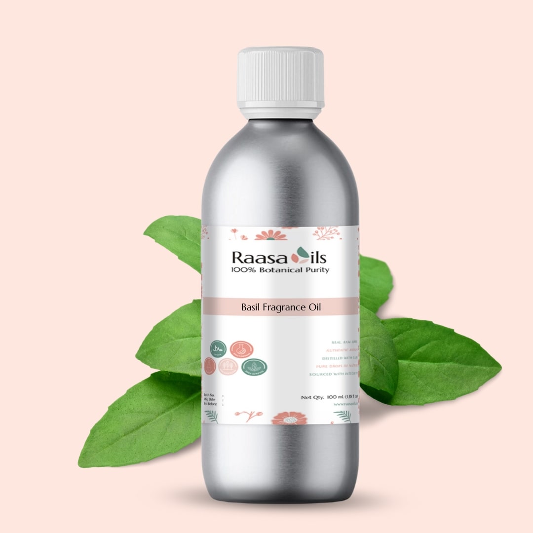 Bottle of Raasa Oils Basil Fragrance Oil with green leaves on a light pink background