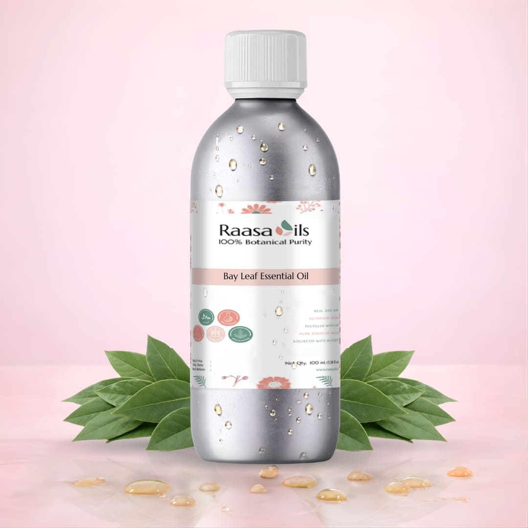 Raasa Oils Bay Leaf Essential Oil bottle with leaves on a pink background