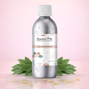 Raasa Oils Bay Leaf Essential Oil bottle with leaves on a pink background