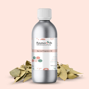 Bottle of Raasa Oils Bay Leaf Fragrance Oil with bay leaves on a light pink background