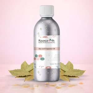 Raasa Oils Bay Leaf Fragrance Oil bottle with leaves on a pink background