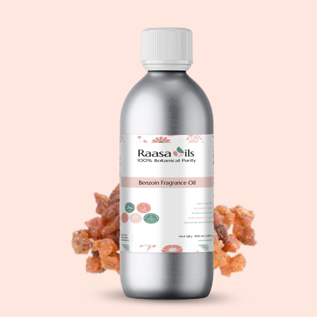 Bottle of Raasa Oils Benzoin Fragrance Oil with dried flowers on a beige background