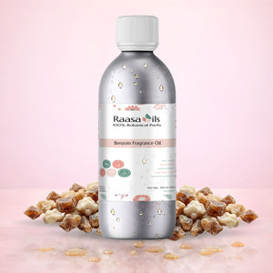 Bottle of Raasa Oils Benzoin Fragrance Oil with Benzoin resin on a pink background