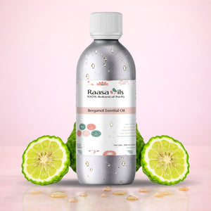 Bottle of Raasa Oils Bergamot Essential Oil with bergamot fruit slices on a pink background