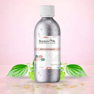 Raasa Oils bottle with green leaves and seeds on a pink background