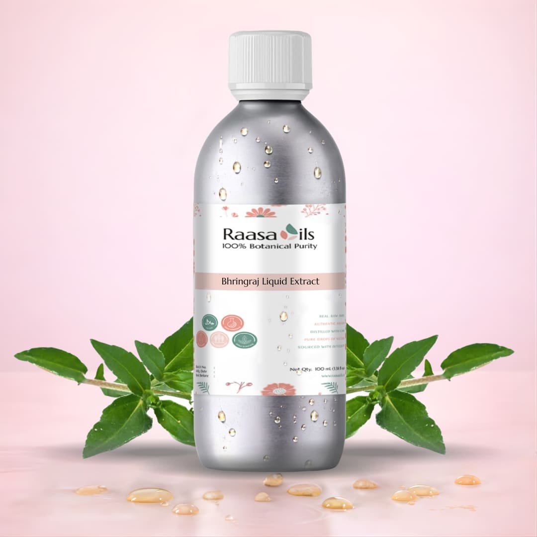 Bottle of Raasa Oils Bhringraj Liquid Extract with green leaves on a pink background