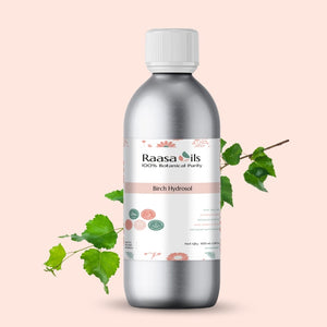 Bottle of Raasa Oils Birch Hydrosol with a branch on a light pink background