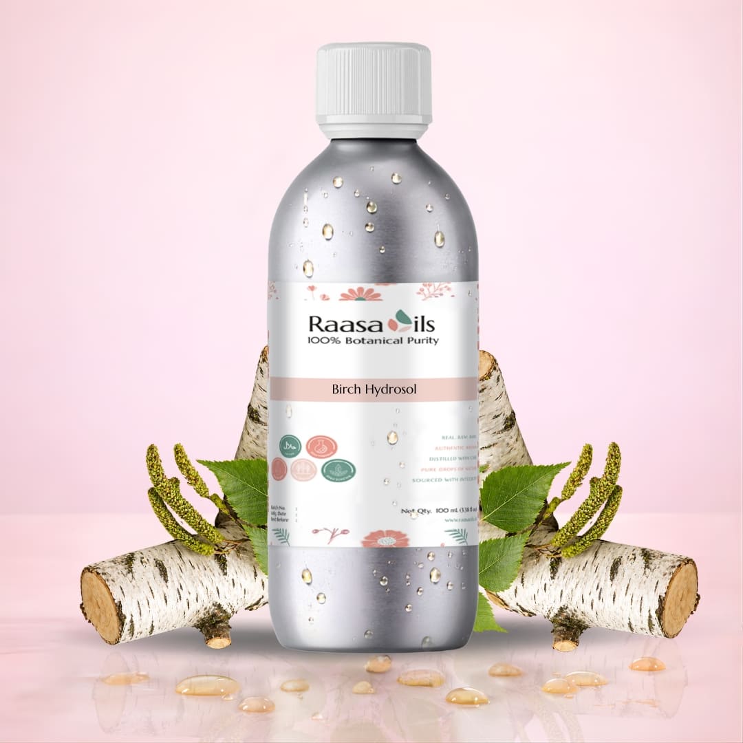 Bottle of Raasa Oils Birch Hydrosol with birch branches and leaves on a pink background