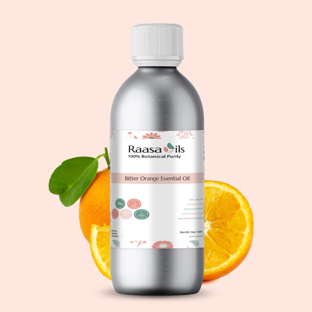 Bottle of Raasa Oils Bitter Orange Essential Oil with oranges on a beige background