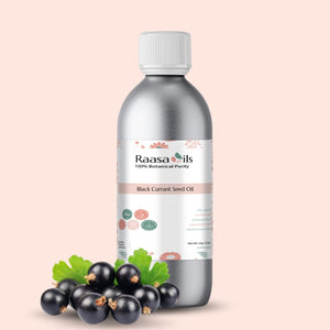 Bottle of Raasa Oils Black Currant Seed Oil with black currants on a beige background