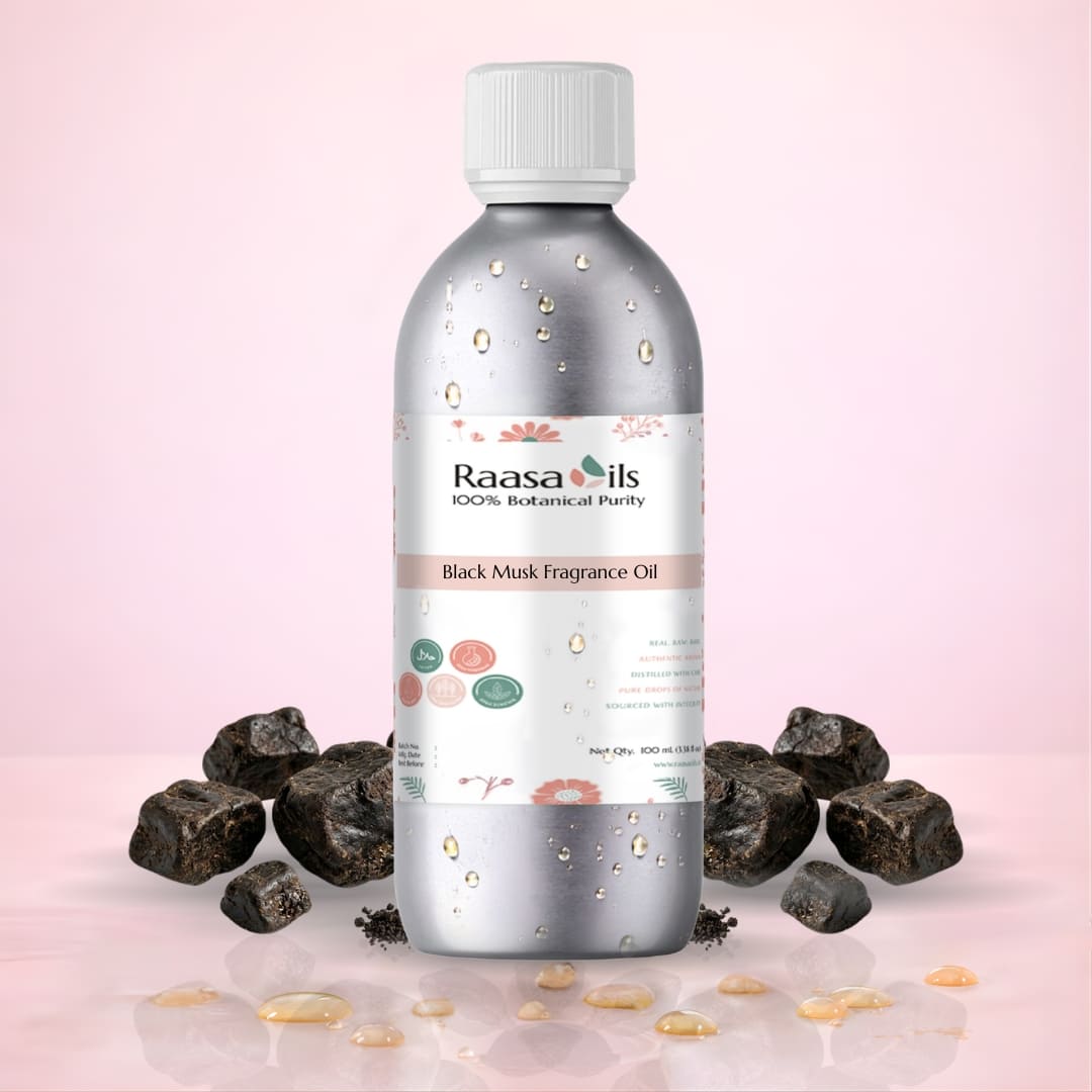 Bottle of Raasa Oils Black Musk Fragrance Oil with black musk stones on a pink background