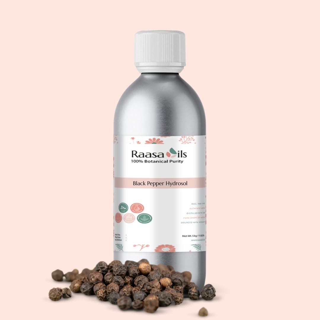 Raasa Oils Black Pepper Hydrosol bottle with black peppercorns on a light pink background
