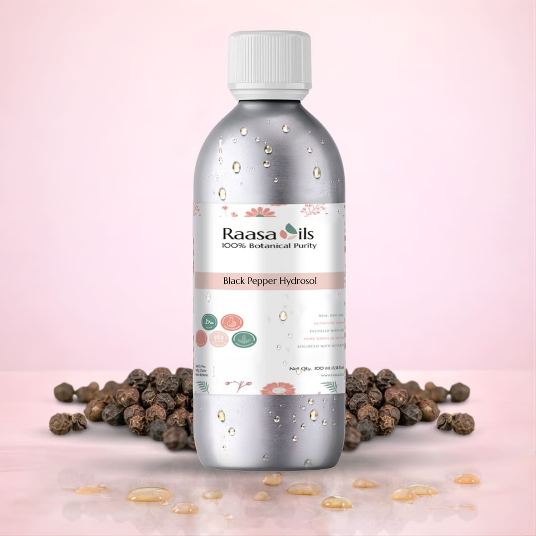 Raasa Oils Black Pepper Hydrofol bottle with black peppercorns on a pink background