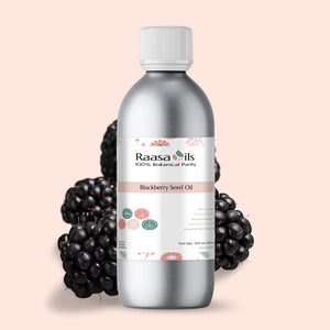 Bottle of Raasa Oils Blackberry Seed Oil with blackberries on a light pink background