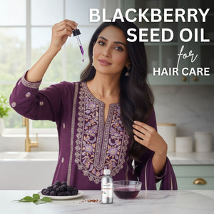 Woman with long hair holding blackberry seed oil dropper in a kitchen setting