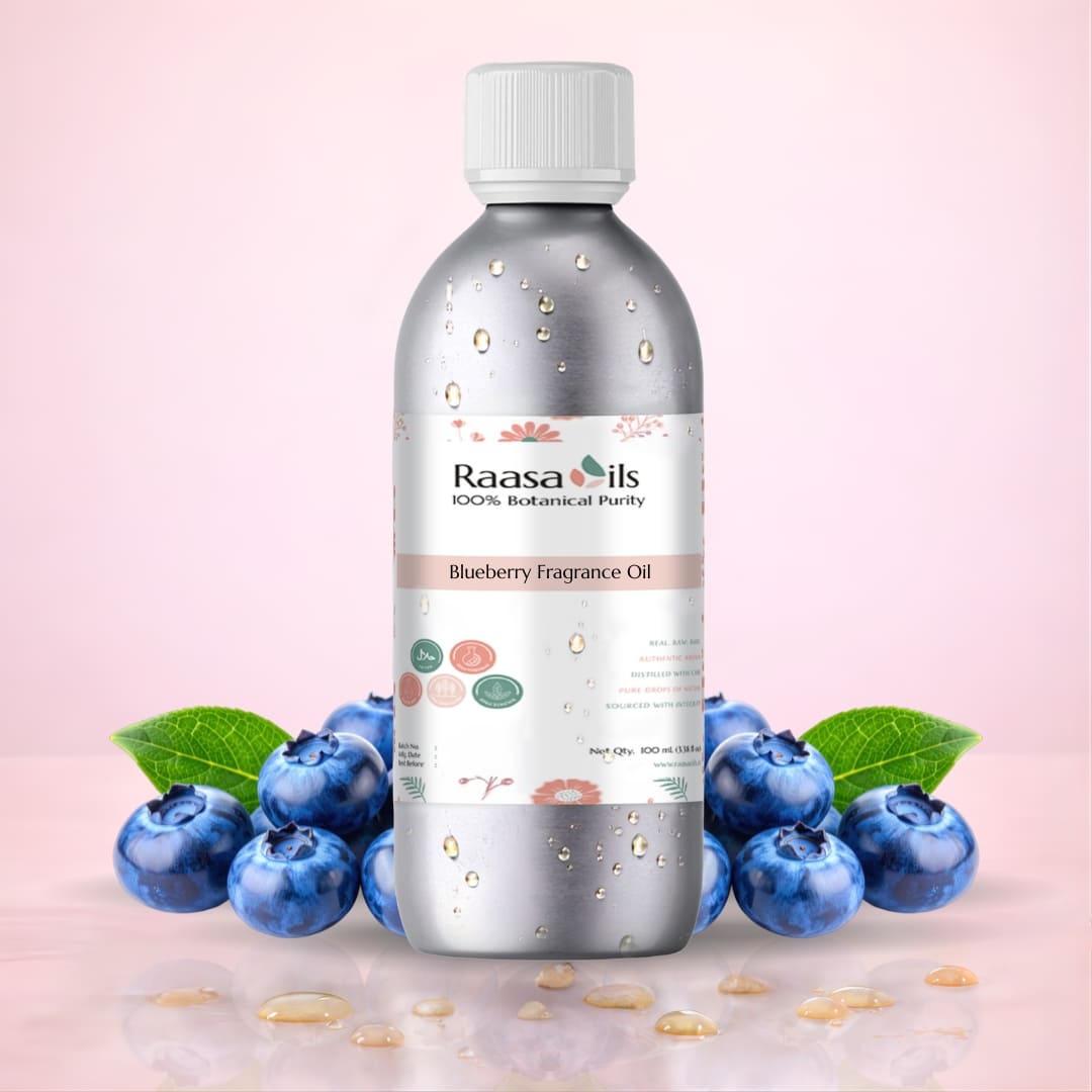 Bottle of Raasa Oils Blueberry Fragrance Oil with blueberries on a pink background