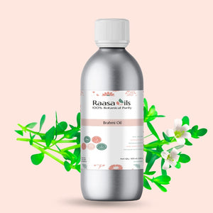 Bottle of Raasa Oils with botanical elements on a light pink background