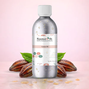 Raasa Oils bottle with cacao beans and leaves on a pink background