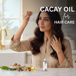 Woman with long hair holding a bottle of Cacay oil for hair care in a kitchen setting.