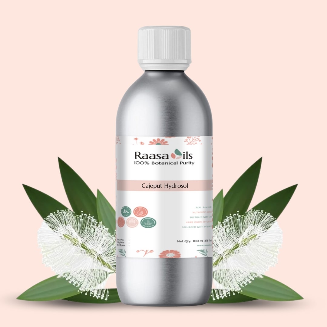 Bottle of Raasa Oils Cajuput Hydrofol with leaves on a light pink background