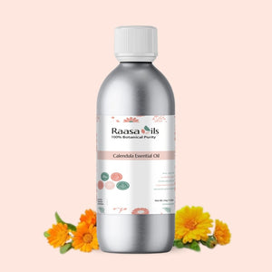 Bottle of Raasa Oils Calendula Essential Oil with calendula flowers on a light pink background