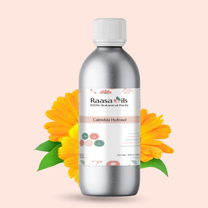Bottle of Raasa Oils Calendula Hydrosol with calendula flowers on a light pink background