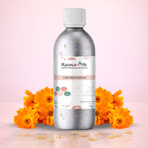 Raasa Oils bottle with calendula flowers on a pink background