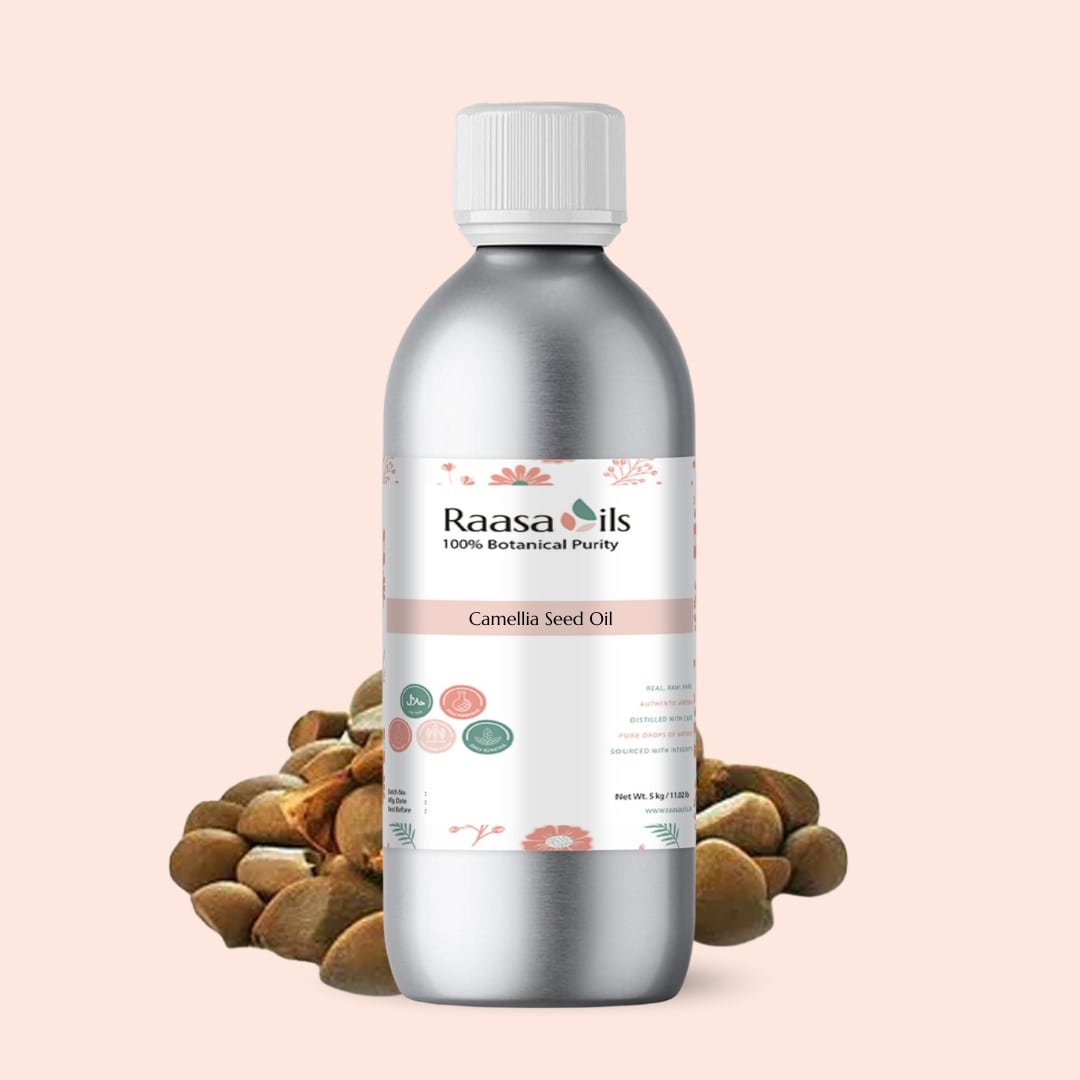 Bottle of Raasa Oils Camellia Seed Oil with seeds on a light pink background