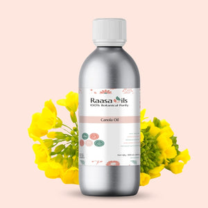 Bottle of Raasa Oils Canola Oil with yellow flowers on a light pink background