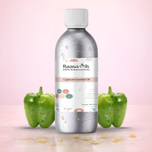 Bottle of Raasa Oils Capsicum Essential Oil with two green peppers on a pink background