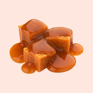Gooey caramel candies on a light pink background
