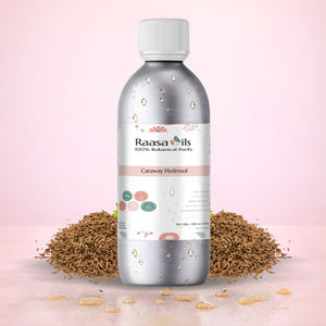 Bottle of Raasa Oils Caraway Hydroxol with caraway seeds on a pink background