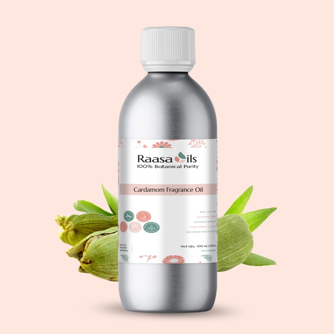 Bottle of Raasa Oils Cardamom Fragrance Oil with cardamom pods on a light pink background