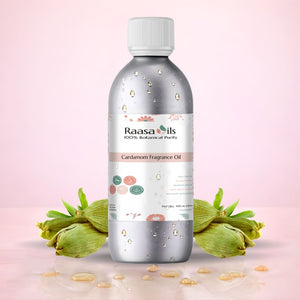 Bottle of Raasa Oils Cardamom Fragrance Oil with cardamom pods on a light pink background