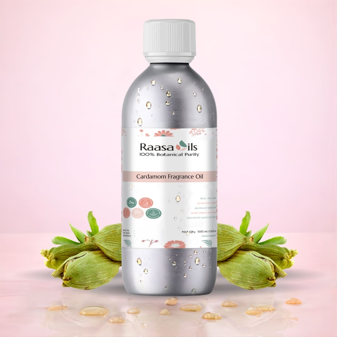 Bottle of Raasa Oils Cardamom Fragrance Oil with cardamom pods on a light pink background